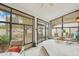 Bright sunroom with tile flooring, multiple chairs, and views of the outside landscape at 19835 N Alta Loma Dr, Sun City West, AZ 85375