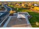 An aerial view of a community playground with basketball court, gazebo, and desert landscaping at 20088 E Maya Rd, Queen Creek, AZ 85142
