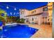Captivating backyard with a refreshing pool, cozy spa, covered patio, and outdoor seating area at 20088 E Maya Rd, Queen Creek, AZ 85142
