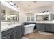 Elegant bathroom with dual vanities, a freestanding tub, and modern fixtures at 20088 E Maya Rd, Queen Creek, AZ 85142