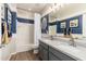 Bathroom with a gray double vanity, a large mirror, stylish lighting, and a shower-tub combination at 20088 E Maya Rd, Queen Creek, AZ 85142