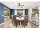 Dining area with large window, ceiling fan, round table with six chairs, and sliding door access to the backyard at 20088 E Maya Rd, Queen Creek, AZ 85142
