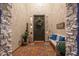 Charming front porch with a decorative wreath, bench with blue pillows, and decorative plants at 20088 E Maya Rd, Queen Creek, AZ 85142