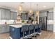 Charming kitchen features gray cabinets, stainless steel appliances, wood countertops, and a stylish blue island at 20088 E Maya Rd, Queen Creek, AZ 85142