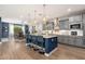 A spacious kitchen with a large center island, wood countertops, stainless appliances, and pendant lighting at 20088 E Maya Rd, Queen Creek, AZ 85142