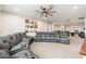 Spacious living room area with a large sectional sofa and a ceiling fan at 20088 E Maya Rd, Queen Creek, AZ 85142