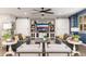 Cozy living room with barn doors, a large TV, comfortable seating, and stylish decor for relaxation at 20088 E Maya Rd, Queen Creek, AZ 85142