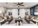 Comfortable living room with two couches, two chairs, ottoman, ceiling fan, and view into other rooms at 20088 E Maya Rd, Queen Creek, AZ 85142