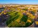 Expansive community park with lush green lawn, walking paths, and mature trees at 20088 E Maya Rd, Queen Creek, AZ 85142