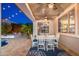 Charming covered patio area with an outdoor dining set, ceiling fans, and decorative rug at 20088 E Maya Rd, Queen Creek, AZ 85142