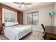 Carpeted bedroom with a murphy bed, cabinets, desk, and a window with blinds at 20215 N Broken Arrow Dr, Sun City West, AZ 85375