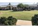 Well-maintained exterior of the condo building with manicured lawn and mature landscaping at 20215 N Broken Arrow Dr, Sun City West, AZ 85375