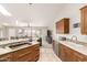 Bright kitchen with an island cooktop and an open view of the adjacent living area at 20215 N Broken Arrow Dr, Sun City West, AZ 85375