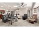 Spacious living room with a skylight, comfortable seating, and a ceiling fan at 20215 N Broken Arrow Dr, Sun City West, AZ 85375