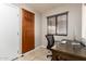 Office space with a cabinet, desk, and a window with blinds at 20215 N Broken Arrow Dr, Sun City West, AZ 85375