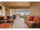 Inviting outdoor patio with comfortable wicker furniture, barbecue, and a view of the fountain and hot tub at 20215 N Broken Arrow Dr, Sun City West, AZ 85375
