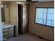 Bright bedroom boasts a ceiling fan, closet, and a vanity with drawers at 205 S Higley Rd # 8, Mesa, AZ 85206
