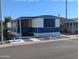 Charming mobile home featuring a screen room and white and blue color scheme at 205 S Higley Rd # 8, Mesa, AZ 85206