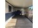 Wide, covered parking area next to a mobile home with a white and blue color scheme at 205 S Higley Rd # 8, Mesa, AZ 85206