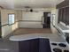 Spacious living room with carpet, ceiling fan, and a view to the kitchen at 205 S Higley Rd # 8, Mesa, AZ 85206