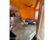A dining area with textured orange walls and ceiling, light fixture, and carpeted floor at 2102 N Garrett Dr, Chandler, AZ 85225