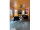A living room with textured orange walls, ceiling fan, wall inset, and furniture with slip covers at 2102 N Garrett Dr, Chandler, AZ 85225