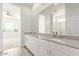 Bathroom featuring double sinks, large mirror, and tiled floors at 21965 E Nightingale Ct, Queen Creek, AZ 85142