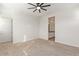 Bedroom featuring plush carpet, a ceiling fan, and ensuite bath at 21965 E Nightingale Ct, Queen Creek, AZ 85142