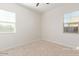 Carpeted bedroom offers lots of natural light with two bright windows at 21965 E Nightingale Ct, Queen Creek, AZ 85142