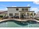 A covered patio with outdoor seating overlooks the backyard pool and fenced yard at 2280 E Stephens Pl, Chandler, AZ 85225