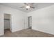 A clean bedroom features neutral carpet, a ceiling fan, and two doors at 2280 E Stephens Pl, Chandler, AZ 85225