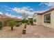 Well maintained backyard features a stone patio and desert landscaping at 229 E Alcatara Ave, Queen Creek, AZ 85140
