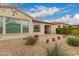 Beautiful backyard view featuring desert landscaping, lush greenery, and a paved patio, perfect for outdoor enjoyment at 229 E Alcatara Ave, Queen Creek, AZ 85140