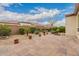 Serene backyard featuring a paved patio, desert landscaping, and privacy wall, creating a tranquil outdoor retreat at 229 E Alcatara Ave, Queen Creek, AZ 85140