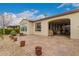 Expansive backyard with a paved patio, desert landscaping, and a covered patio, ideal for outdoor living and entertaining at 229 E Alcatara Ave, Queen Creek, AZ 85140