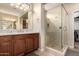 Bathroom featuring a glass enclosed shower with granite countertops and brown cabinets at 229 E Alcatara Ave, Queen Creek, AZ 85140