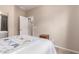 Bright bedroom featuring a quaint nightstand, plush bedding, and simple decor at 229 E Alcatara Ave, Queen Creek, AZ 85140