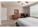 Bright bedroom features a dresser, desk and chair, tile flooring, and neutral paint at 229 E Alcatara Ave, Queen Creek, AZ 85140