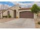 Inviting one-story house with a well-maintained yard, sheltered entryway, and an attached two-car garage at 229 E Alcatara Ave, Queen Creek, AZ 85140