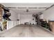 Spacious garage with ample storage, utility sink, and epoxy flooring is perfect for car enthusiasts and hobbyists alike at 229 E Alcatara Ave, Queen Creek, AZ 85140