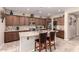 Spacious kitchen features a central island, sleek appliances, and stone countertops at 229 E Alcatara Ave, Queen Creek, AZ 85140
