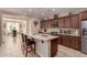 Well-equipped kitchen with granite countertops, a central island and stainless steel appliances at 229 E Alcatara Ave, Queen Creek, AZ 85140