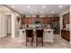 Open-concept kitchen with granite countertops, a central island and ample cabinetry at 229 E Alcatara Ave, Queen Creek, AZ 85140
