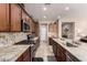 Gourmet kitchen with stainless steel appliances, granite countertops, and custom cabinetry at 229 E Alcatara Ave, Queen Creek, AZ 85140