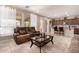 Bright and open living space with tile flooring flowing into the dining area and kitchen at 229 E Alcatara Ave, Queen Creek, AZ 85140