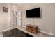 Stylish living room featuring modern decor, a wall-mounted TV, and tiled floors at 229 E Alcatara Ave, Queen Creek, AZ 85140