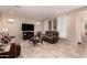 Comfortable living room featuring tile floors, a large TV, and multiple leather sofas at 229 E Alcatara Ave, Queen Creek, AZ 85140