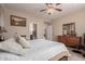 Cozy main bedroom featuring a ceiling fan, art, and natural light at 229 E Alcatara Ave, Queen Creek, AZ 85140