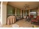 Relaxing covered patio featuring ample seating and a ceiling fan, great for entertaining or unwinding in comfort at 229 E Alcatara Ave, Queen Creek, AZ 85140