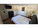 Bright bedroom with wood flooring, complemented by a black dresser and neutral paint at 239 E Betty Elyse Ln, Phoenix, AZ 85022